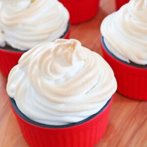 Banana Meringue Pie with caramelized bananas and fluffy meringue topping served in red ramekins