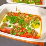 shakshuka with vegetarian meatballs served on a white dish.