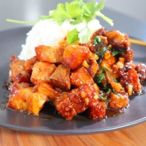 Crispy Air Fryer pork belly served with Asian-style garlic chili sauce on a white plate