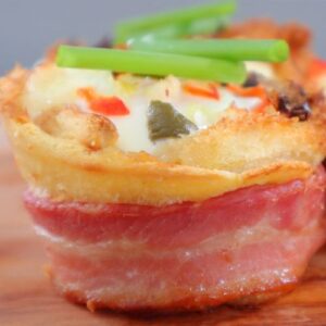 Air fryer breakfast toast with egg, bacon, cheese, and vegetables on brioche bread.