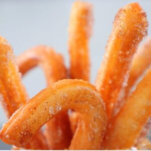 golden homemade churros coated in cinnamon sugar
