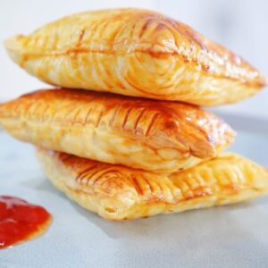 Golden puff pastry stuffed with creamy tuna filling on a plate
