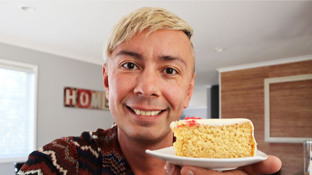 man holding a slice of cake on serving plate