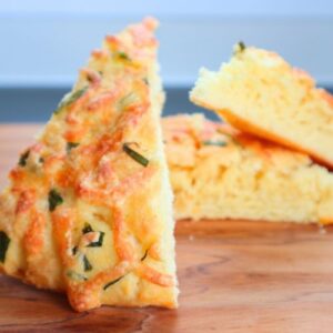 Fluffy homemade cheese bread topped with scallions and melted mozzarella