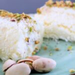 Creamy Turkish milk dessert rolls topped with crushed pistachios and coconut flakes