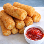 Golden potato croquettes served with ketchup