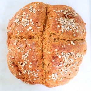 Easy Irish soda bread loaf with oats topping, freshly baked and golden crust