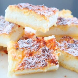 Stacked lemon yogurt slice bars with creamy texture and powdered sugar